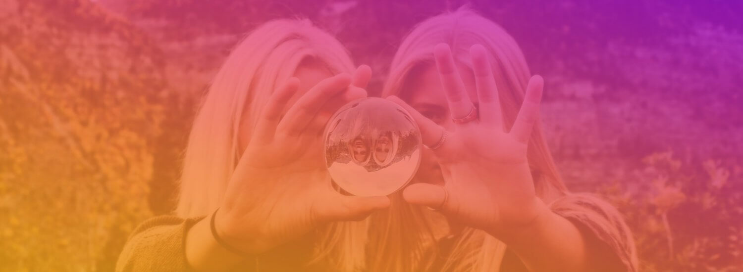 2 woman holding a lens ball
