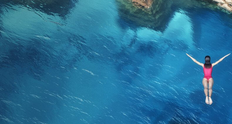 woman diving in to ocean
