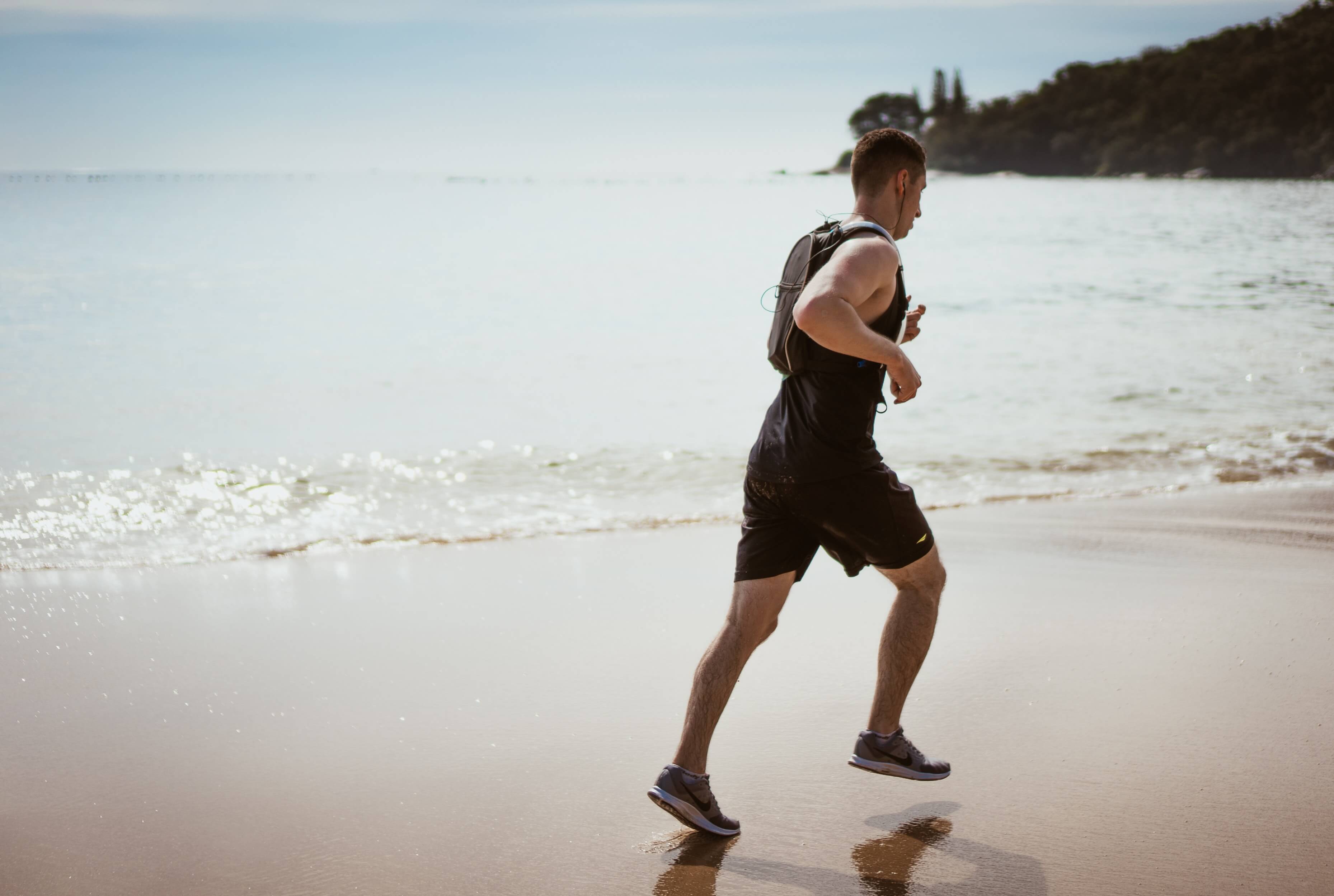 man running on beach 