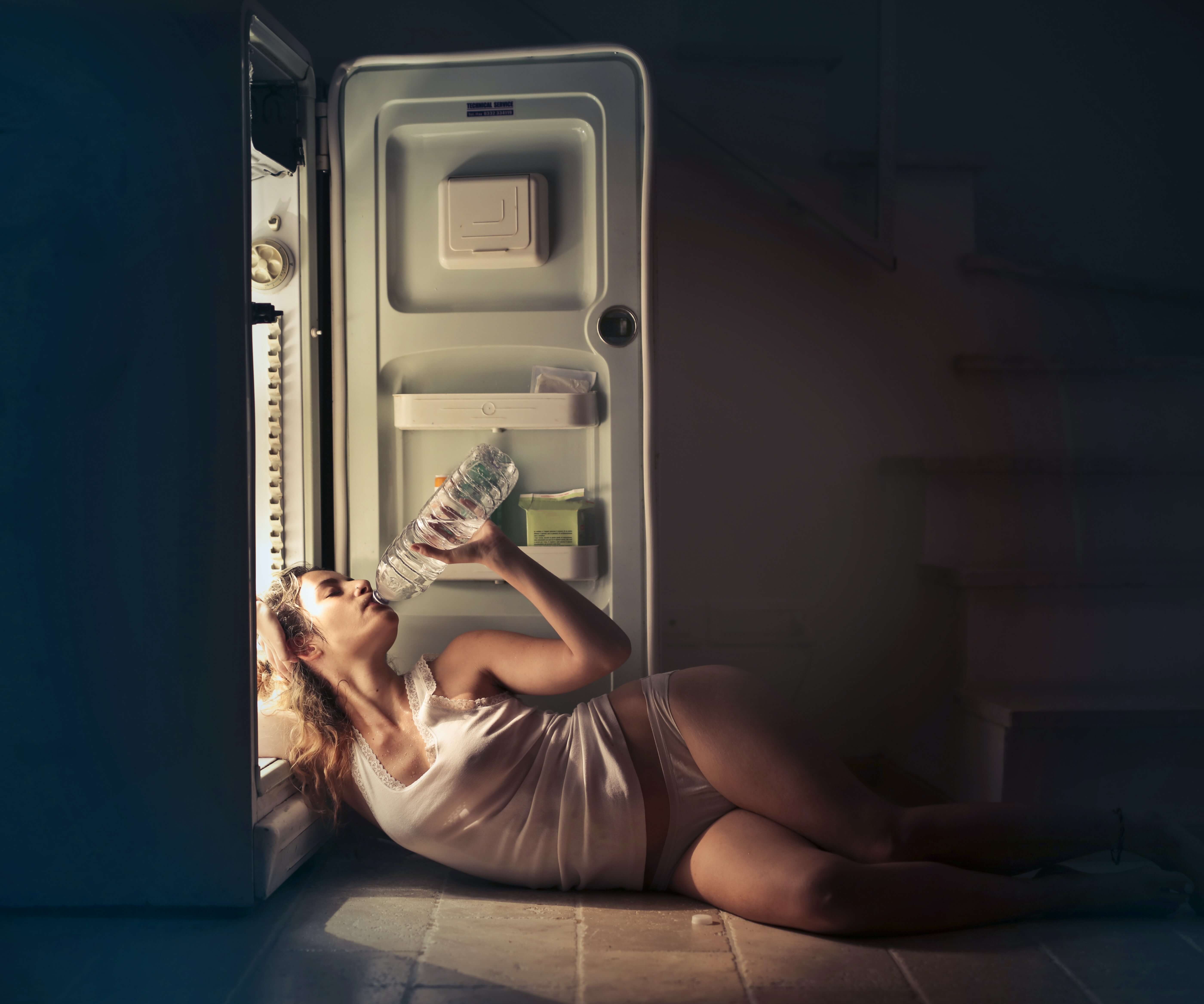 photo-of-woman-in-white-vest-and-panties-lying-on-floor-next