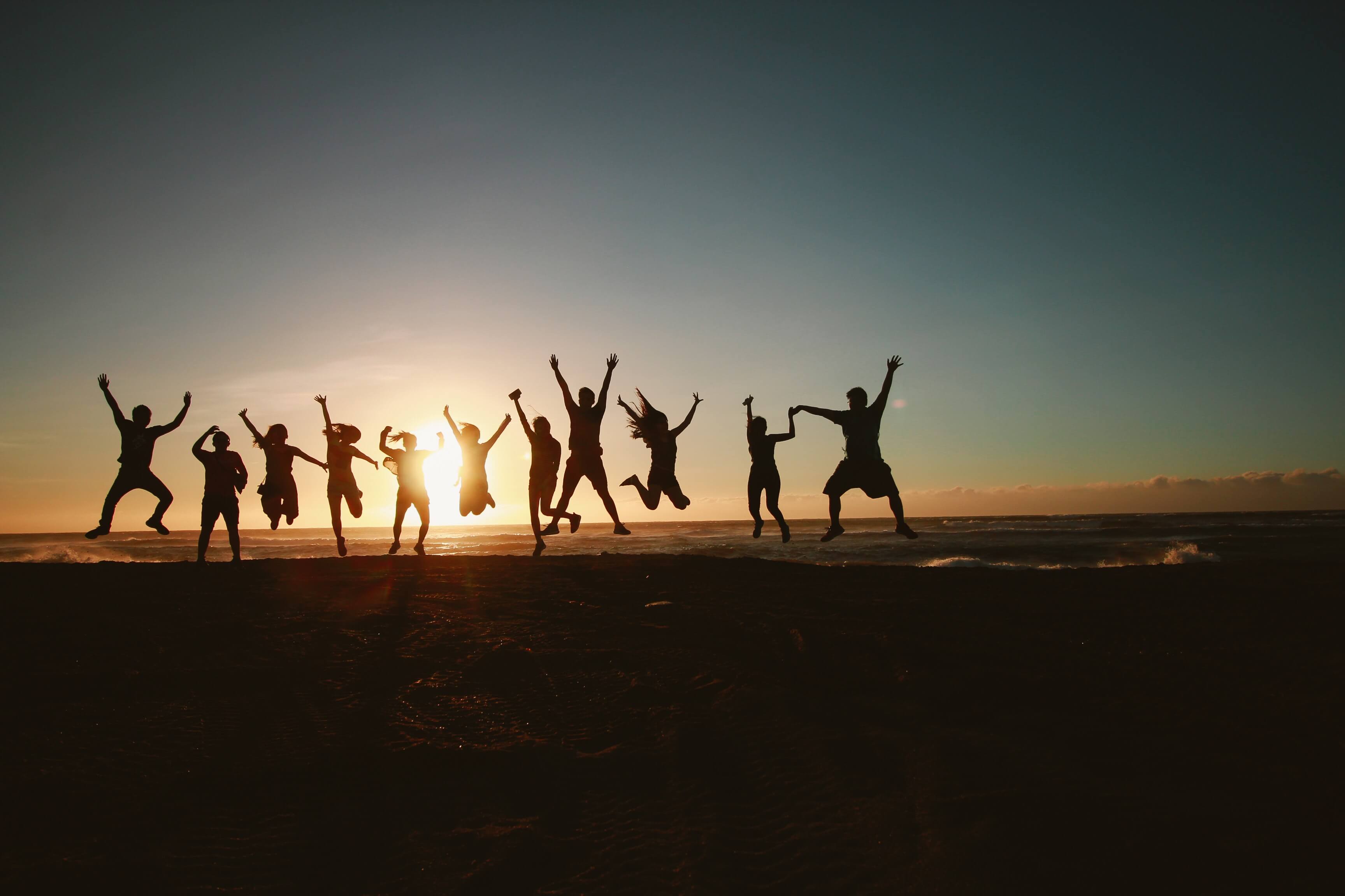 silhouette-photography-of-group-of-people-jumping-during